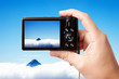 Tourist's hand holding photo camera