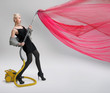 Young woman using vacuum cleaner. Isolated.