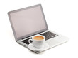 Hot cappuccino cup on laptop Hot cappuccino cup on laptop