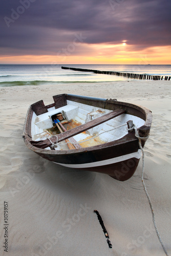 Photo: Boat on beautiful beach in sunrise Boat on beautiful beach in sunrise