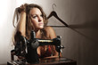 Beautiful creative woman using sewing machine