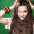 portrait of a winking young girl over green