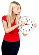 Young beautiful woman with the clock