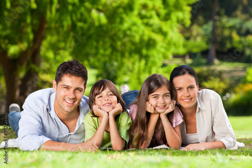 Photo: Family lying down in the park Family lying down in the park