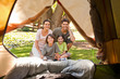 Joyful family camping in the park