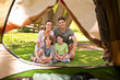 Joyful family camping in the park