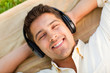 Young man listening to music in the park