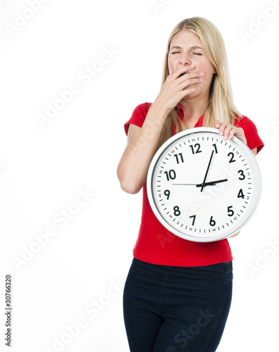 Photo: tired young woman with the clock tired young woman with the clock