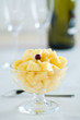Pineapple dessert with glasses and bottle in background
