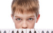 Sad boy near piano keyboard Sad boy near piano keyboard