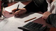 business woman fills out a 1040 tax form. slider shot.