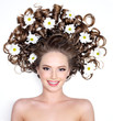 Beautiful smiling woman with flowers in hair