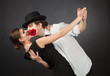 Professional dancers, girl holding rose in mouth