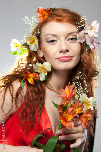 Photo: Portrait of beautiful woman with spring flowers Portrait of beautiful woman with spring flowers