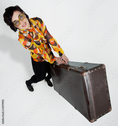 Photo: Beautiful woman posing at studio with baggage Beautiful woman posing at studio with baggage