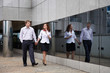 Romantic couple on walk along mirror of modern building