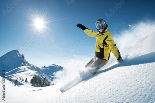 Photo: Young snowboarder in deep powder - extreme freeride Young snowboarder in deep powder - extreme freeride
