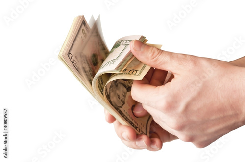 Photo: The human hand holding a bunch of USA dollars The human hand holding a bunch of USA dollars