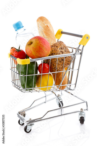 Photo: Shopping trolley full of goods on white background Shopping trolley full of goods on white background