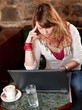 Morning coffee in internet cafe - Beautiful young girl checking Morning coffee in internet cafe - Beautiful young girl checking