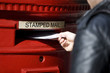 A man posting letters in a letterbox