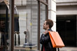 A young man looking in a shop window