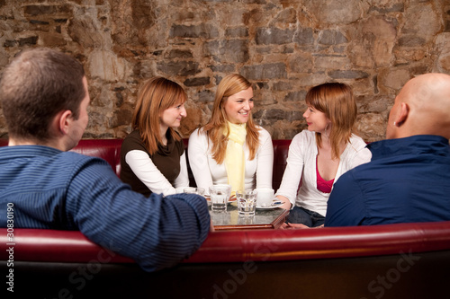Photo: Group of five people having fun in cafe Group of five people having fun in cafe