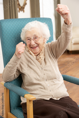 Photo: Senior Woman Celebrating In Chair At Home Senior Woman Celebrating In Chair At Home