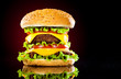 Tasty and appetizing hamburger on a darkly red Tasty and appetizing hamburger on a darkly red