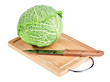 Fresh green savoy cabbage with knife on wooden chopping board