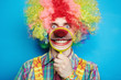 Photo: Portrait cheerful clown with the big smile on a blue background Portrait cheerful clown with the big smile on a blue background