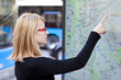 Foto: Woman looking on the metro map board Woman looking on the metro map board