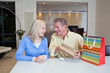 Couple celebrating birthday with gift bags