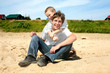 happy teenager and kid on the beach happy teenager and kid on the beach