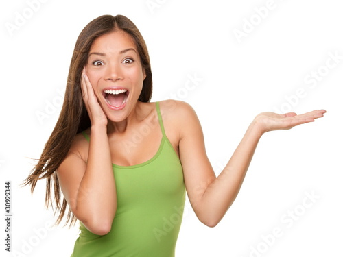 Photo: Surprised woman showing product Surprised woman showing product
