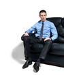 Young attractive bossy businessman sitting on the sofa. Young attractive bossy businessman sitting on the sofa.