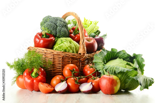 Photo: Vegetables in wicker basket isolated on white Vegetables in wicker basket isolated on white