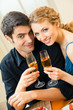 Young couple celebrating with champagne at home Young couple celebrating with champagne at home
