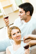 Young happy couple celebrating with redwine at home Young happy couple celebrating with redwine at home