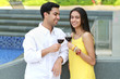 Young romantic couple celebrating with wine.
