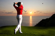 Man playing golf against sunset Man playing golf against sunset