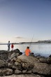 Father with two suns fishing on Paradise beach of Langebaan, South Africa