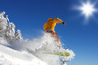 Snowboarder  jumping against blue sky