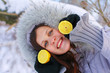 The girl is holding lemon halves in wood on a frost