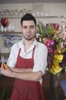 Florist stands with flower arrangement