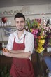 Florist stands with flower arrangement