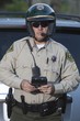 Patrol officer stands with luxury car