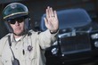 Patrol officer stops traffic, police escort