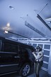 Nightwatch patrolman checks luxury car in garage