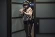 Nightwatch patrolman at doorway with rifle
